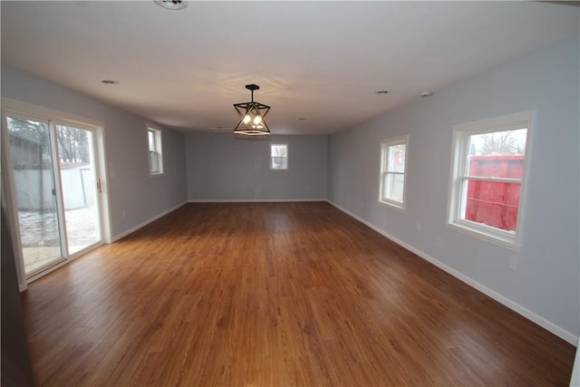 unfurnished room with wood finished floors and baseboards