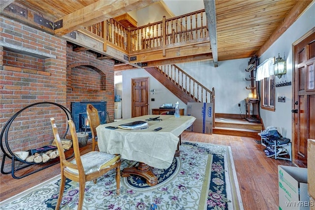 dining area featuring stairs, hardwood / wood-style floors, beamed ceiling, and wood ceiling