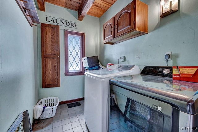 washroom with washing machine and dryer, wooden ceiling, cabinet space, and light tile patterned flooring