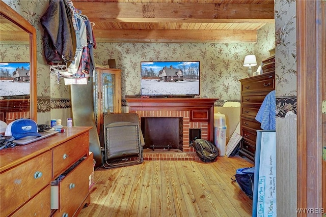 unfurnished room with beam ceiling, wooden ceiling, hardwood / wood-style floors, and wallpapered walls