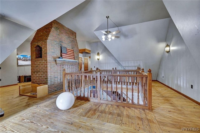 additional living space with a ceiling fan, lofted ceiling, wood-type flooring, and baseboards