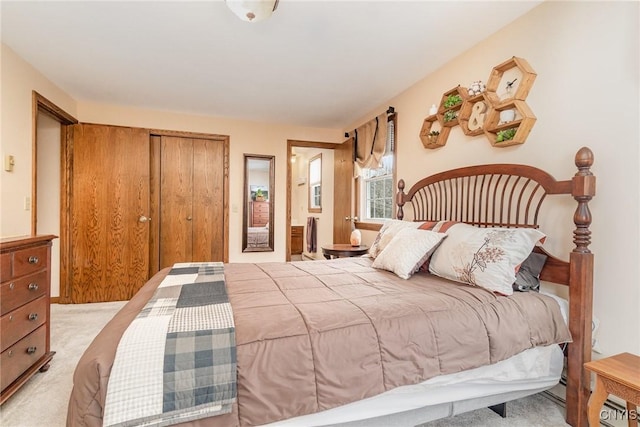 bedroom featuring a closet, carpet, and ensuite bath