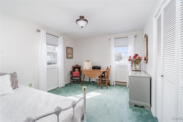 carpeted bedroom featuring baseboards, baseboard heating, and a closet