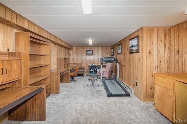 workout area featuring wood walls and light colored carpet