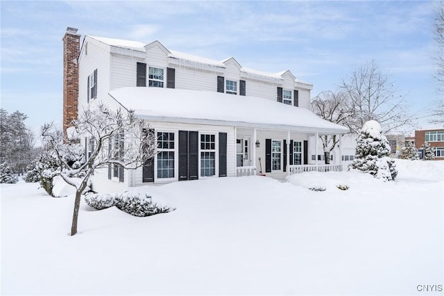 view of front of property featuring a chimney and a porch