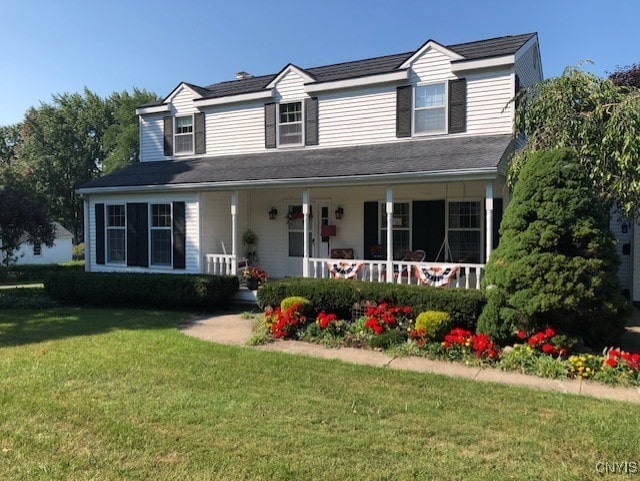 view of front of property with a porch and a front lawn