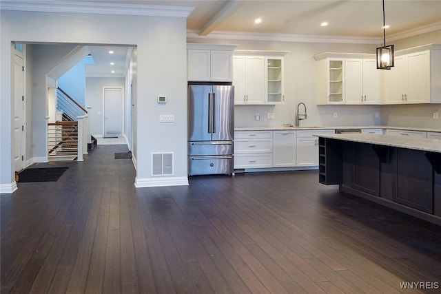 kitchen with glass insert cabinets, white cabinets, dark wood-style flooring, and freestanding refrigerator