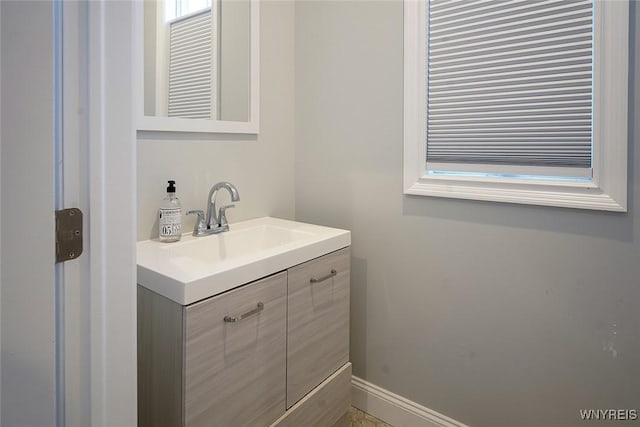 bathroom with baseboards and vanity