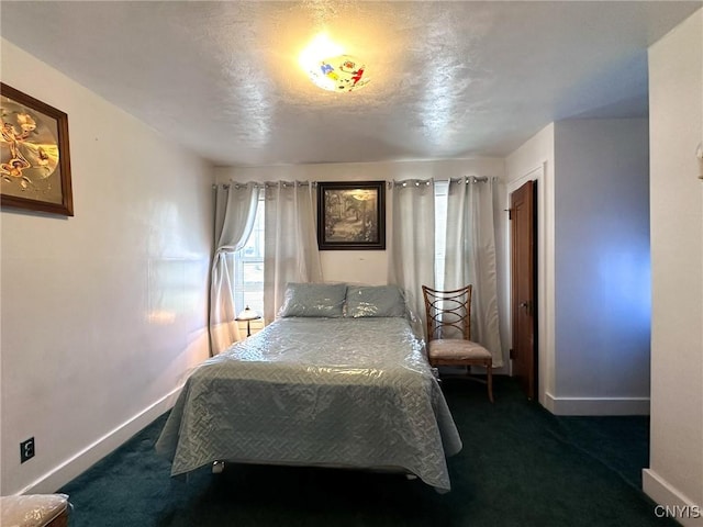 bedroom featuring dark carpet and baseboards