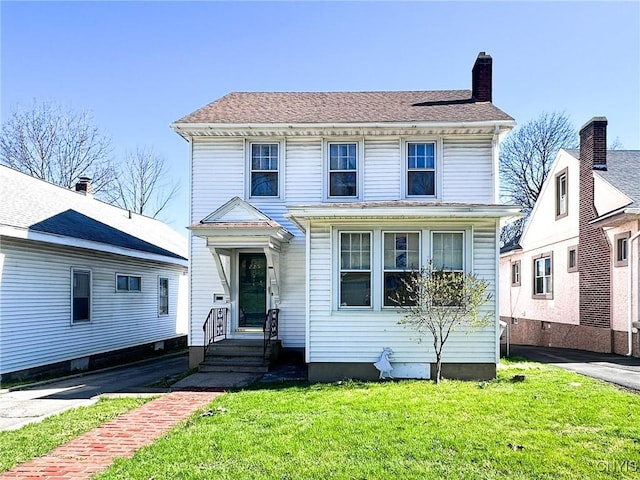 traditional style home with a chimney and a front yard