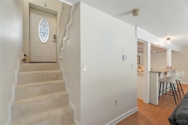 stairway featuring baseboards and wood finished floors