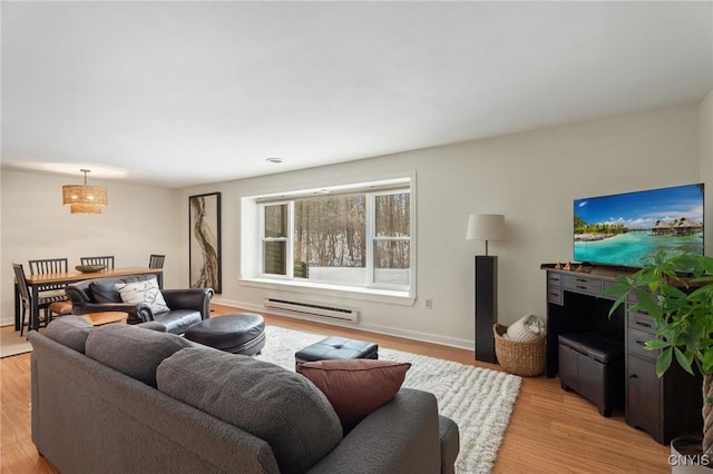 living room featuring light wood-style flooring, a baseboard heating unit, and baseboards