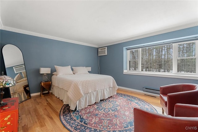 bedroom featuring wood finished floors, visible vents, baseboards, an AC wall unit, and crown molding