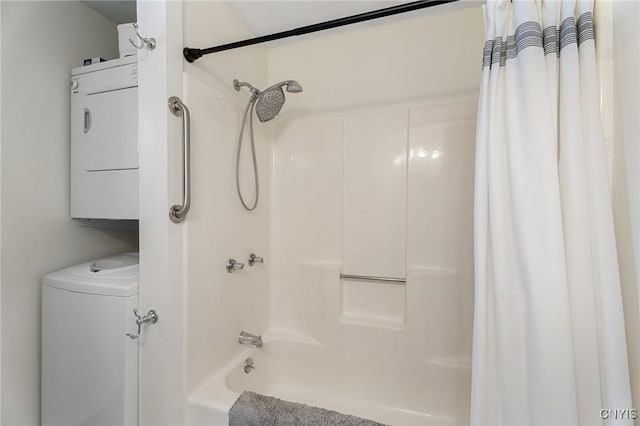 bathroom featuring shower / bath combo and stacked washer / drying machine