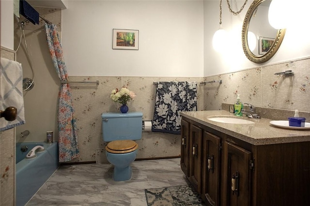 full bath featuring shower / bath combo, wainscoting, vanity, and toilet