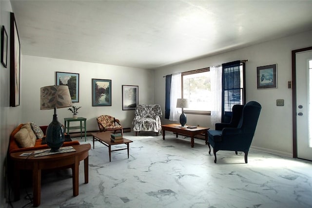 sitting room featuring marble finish floor