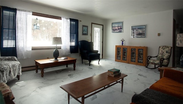 sitting room featuring marble finish floor and baseboards