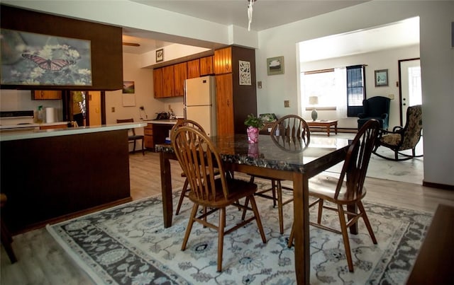 dining area with light wood-style flooring