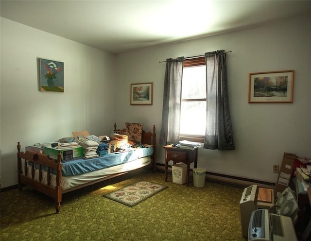 carpeted bedroom featuring a baseboard heating unit