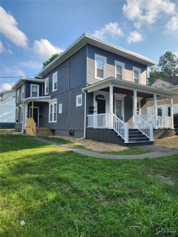 view of front of home with covered porch and a front yard