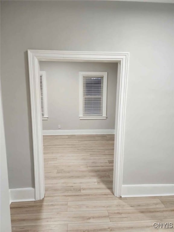 spare room with light wood finished floors and baseboards