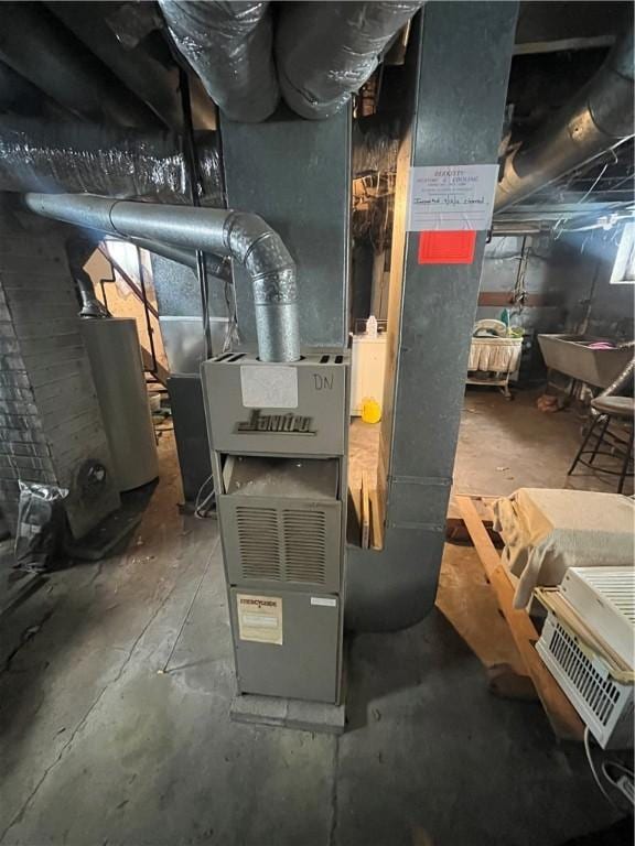 utility room with water heater and heating unit