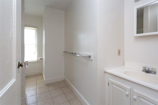 bathroom featuring vanity, baseboards, and tile patterned floors