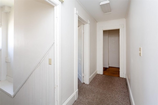 hall with carpet flooring and baseboards