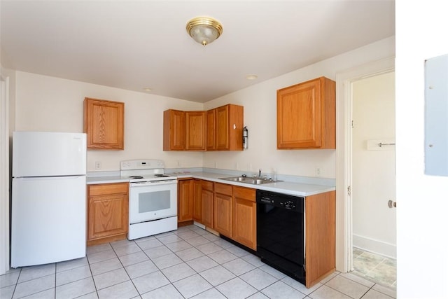 kitchen with light tile patterned floors, white appliances, a sink, light countertops, and brown cabinetry