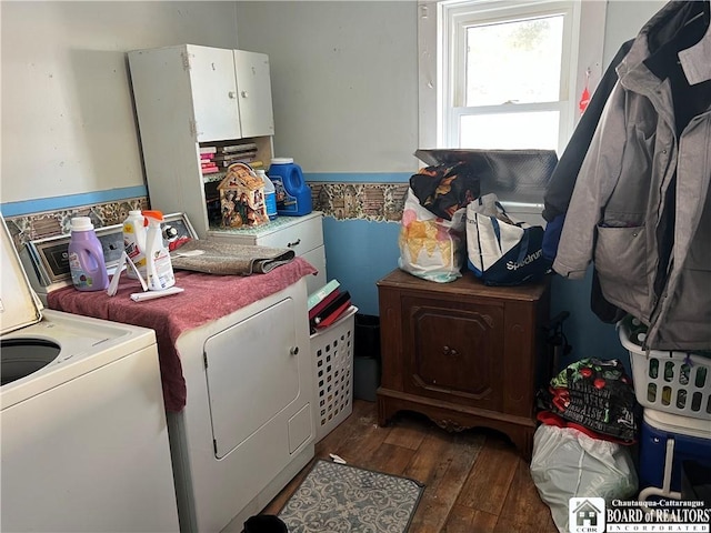 washroom with separate washer and dryer, cabinet space, and hardwood / wood-style floors