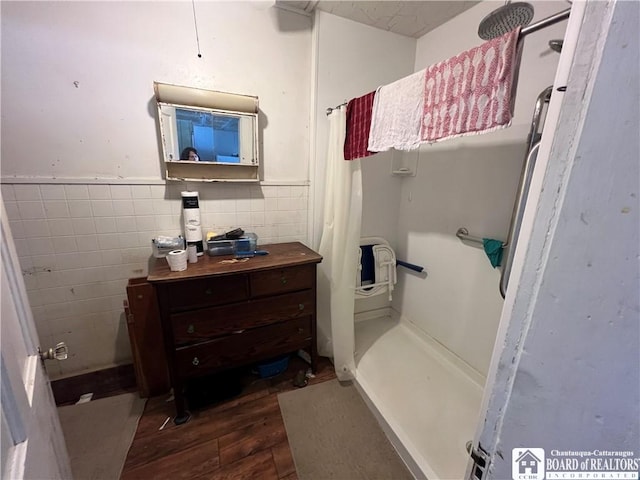 507 E Connell St, Olean-City, NY 14760 - bathroom with a shower stall, wainscoting, wood finished floors, and tile walls