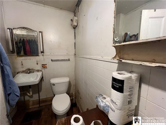 507 E Connell St, Olean-City, NY 14760 - bathroom featuring toilet, tile walls, wood finished floors, and a sink