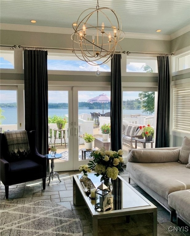 sitting room featuring recessed lighting, crown molding, a water view, stone tile flooring, and an inviting chandelier