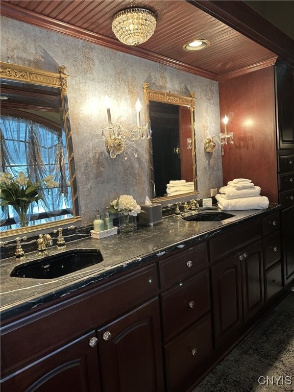 bathroom featuring ornamental molding, wooden ceiling, a sink, and double vanity