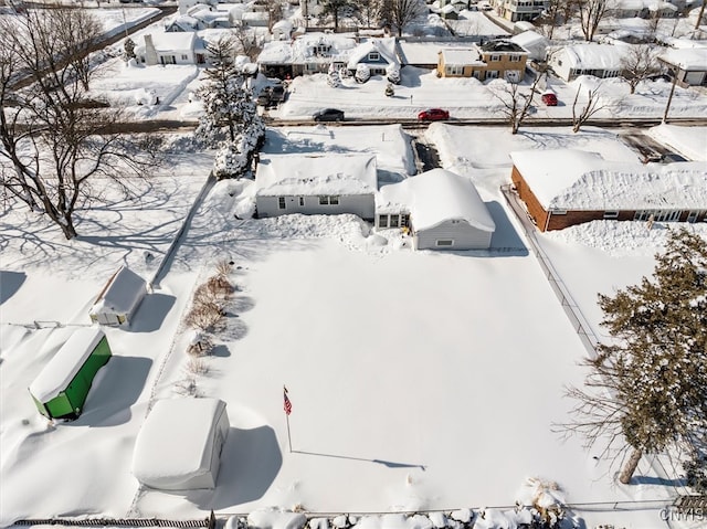 snowy aerial view with a residential view