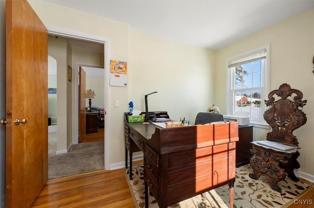 home office featuring baseboards and wood finished floors