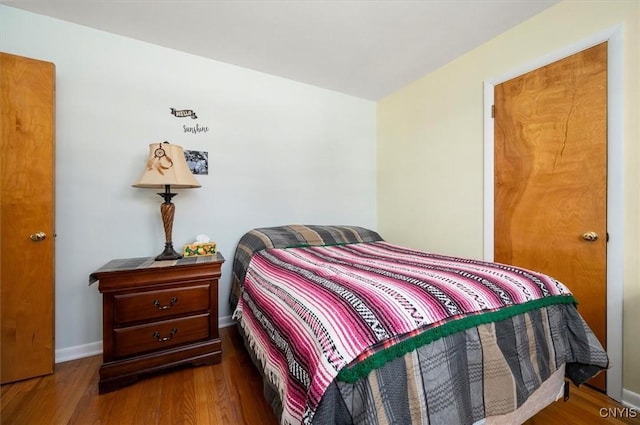 bedroom featuring baseboards and wood finished floors