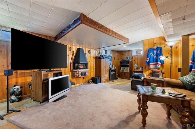 living area with carpet floors and wood walls