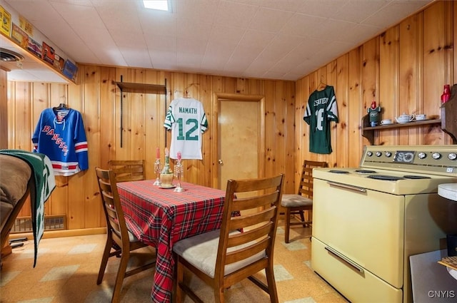 dining space with light floors, washer / clothes dryer, wood walls, and visible vents