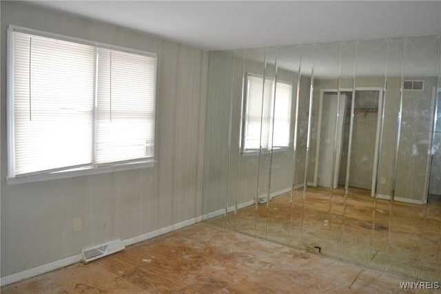 spare room with visible vents and baseboards