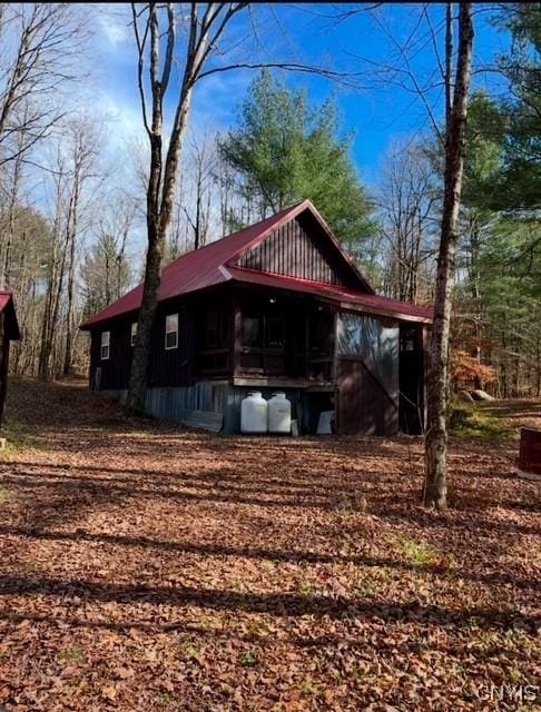 view of side of home featuring metal roof