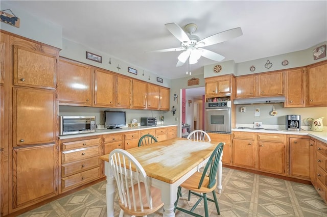 284 Main St, Worcester, NY 12197 - kitchen with white stovetop, under cabinet range hood, light countertops, light floors, and stainless steel oven
