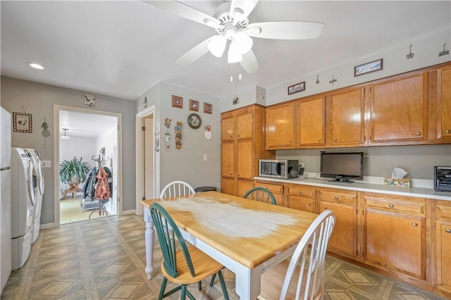 284 Main St, Worcester, NY 12197 - kitchen with brown cabinetry, stainless steel microwave, light countertops, light floors, and separate washer and dryer