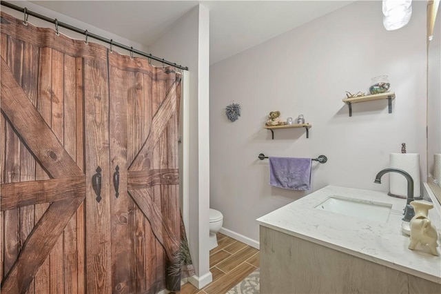 284 Main St, Worcester, NY 12197 - full bathroom with wood tiled floor, baseboards, vanity, and toilet