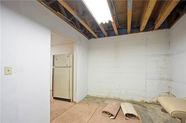 284 Main St, Worcester, NY 12197 - unfinished below grade area with concrete block wall and freestanding refrigerator