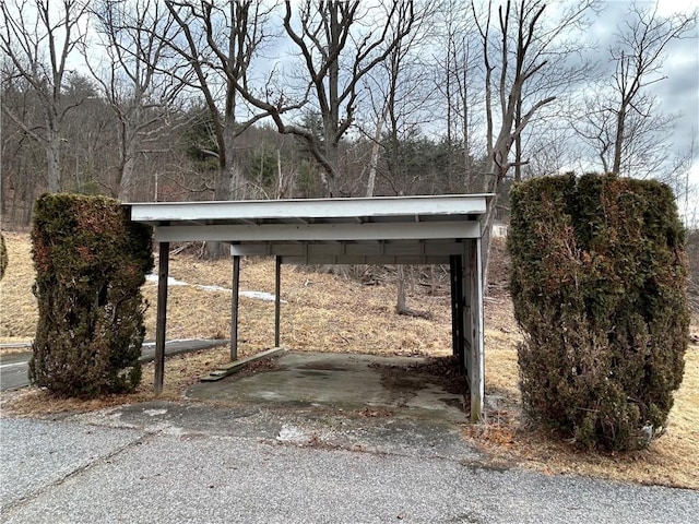 view of parking / parking lot featuring a carport and aphalt driveway