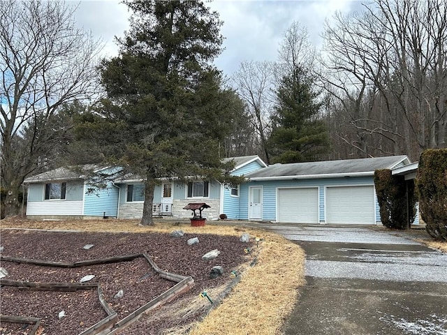 single story home with an attached garage and driveway