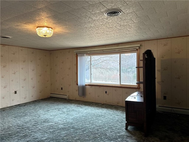 unfurnished room with visible vents, carpet floors, and baseboard heating