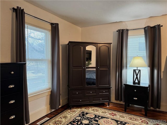 bedroom featuring light wood finished floors, multiple windows, and visible vents