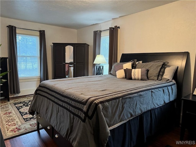 bedroom featuring a textured ceiling and wood finished floors